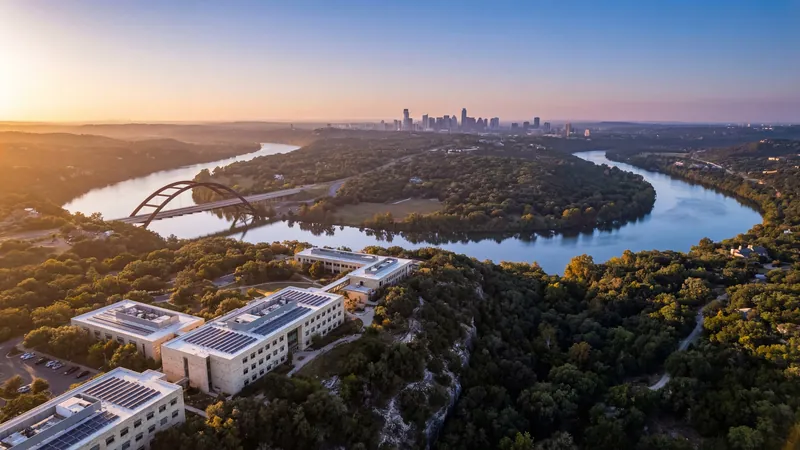 Aerial view of a campus by a winding river at sunset