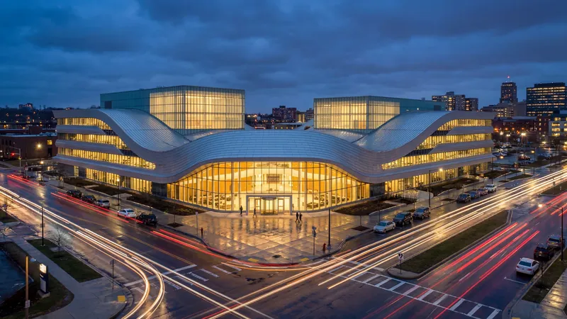 Curved office building above a lit street at blue hour