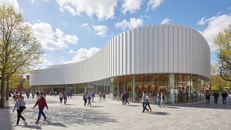 White curved building on a busy plaza