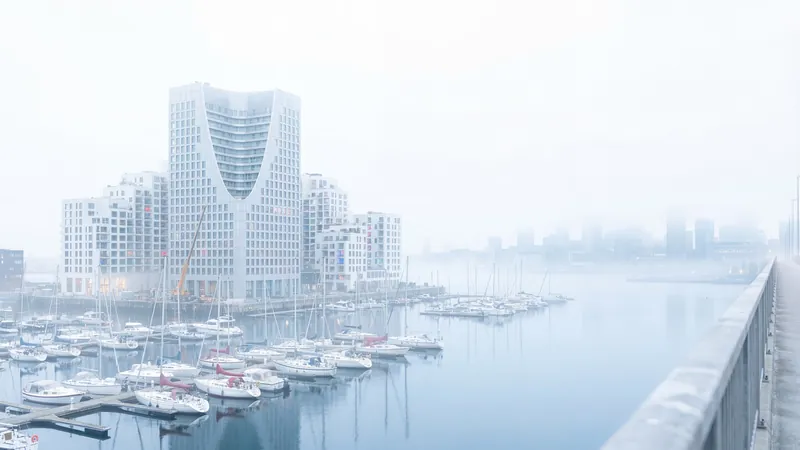 White tower in the fog above a marina