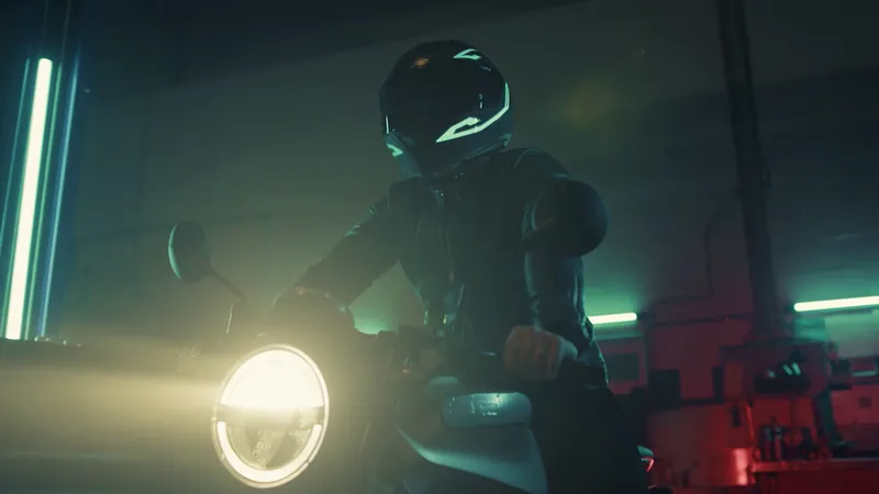 Motorcyclist with a glowing helmet and headlight in a dark garage