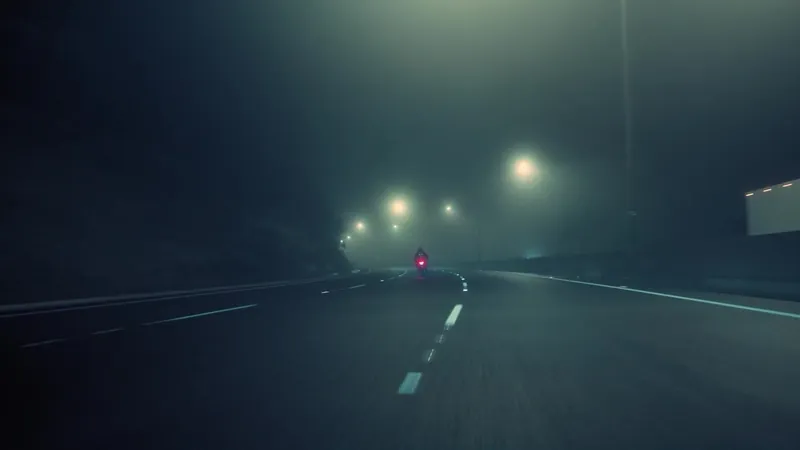 Empty road in the fog at night